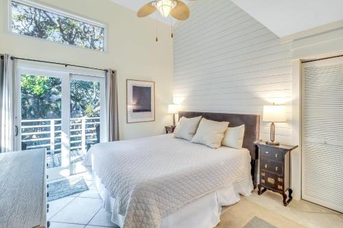 a white bedroom with a bed and a balcony at WS4403: 4403 Windswept in Kiawah Island