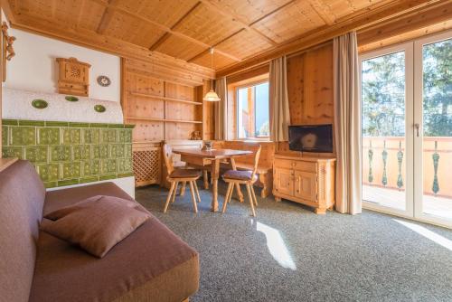 a living room with a bed and a dining room table at Wohnung In Den Dolomiten Mit Traumhafter Aussicht in Kastelruth