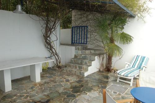 a patio with a staircase and a table and chairs at Cottage in Tiros