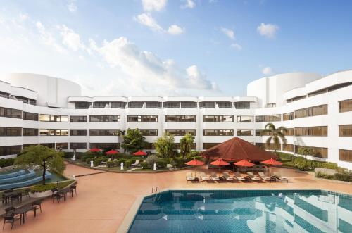an exterior view of a hotel with a swimming pool at Amari Don Muang Airport Bangkok in Bangkok