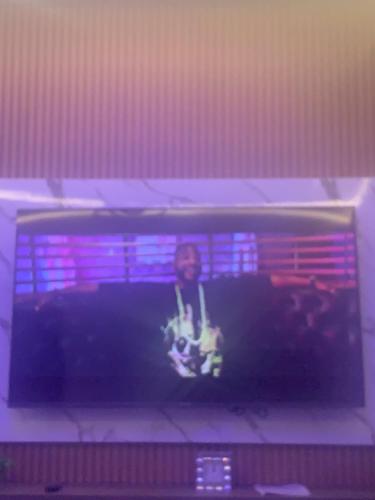 a man sitting in the corner of a boxing ring at Legacy Square Apartment in Accra