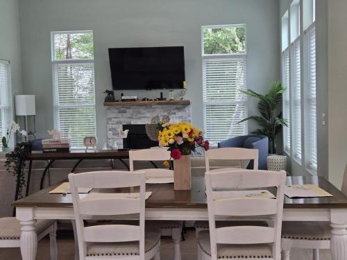 a dining room with a table with chairs and a television at The Backwoods Paradise in Logan