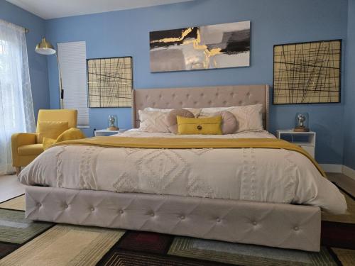 a bedroom with a large bed and a yellow chair at The Backwoods Paradise in Logan