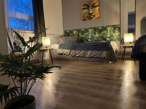 a bedroom with a bed and two tables with lights at Neu Studio Leipzig Zentrum in Leipzig