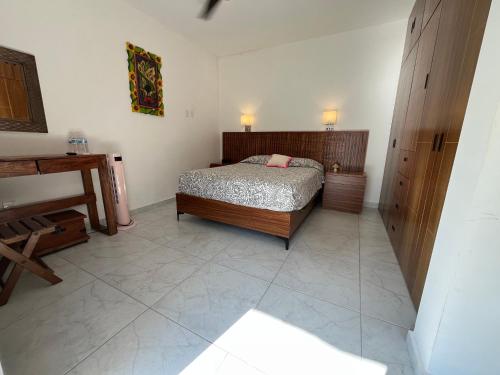 a bedroom with a bed and a piano at Casa amigos Comala in Comala