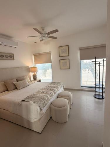 a bedroom with a large bed and a ceiling fan at Modern beach house in San Carlos in San Carlos