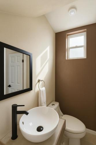 a bathroom with a white sink and a toilet at Stellarium Hotel-Valle de Guadalupe in Francisco Zarco
