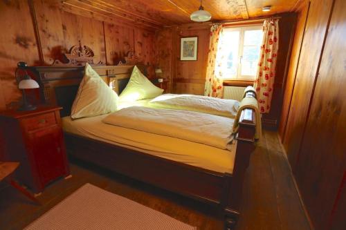 a bedroom with a bed in a wooden room at Maierhof in Bernau im Schwarzwald