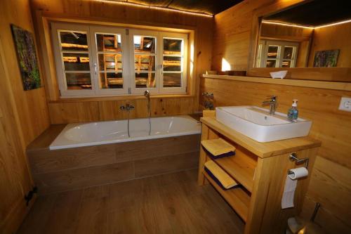 a bathroom with a tub and a sink at Maierhof in Bernau im Schwarzwald