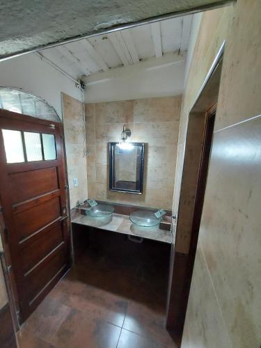 a bathroom with two sinks and a mirror at Rincon de la Selva in La Calera