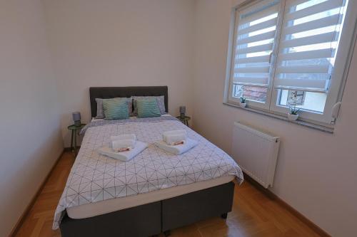 a bedroom with a bed with two pillows on it at Kosta Boutique Apartment in Banja Luka