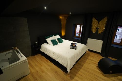 a bedroom with a bed and a tub in it at Le Secret' - Balnéo - Romantique Room in Pélussin