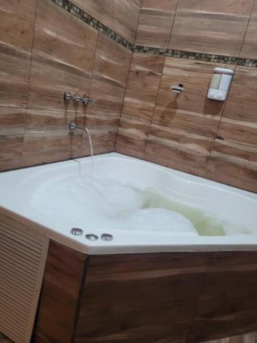 a bath tub with a faucet in a bathroom at Cabaña premium! in Villa Anizacate