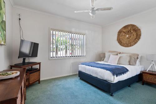 Ένα ή περισσότερα κρεβάτια σε δωμάτιο στο Frangipani At The Bay