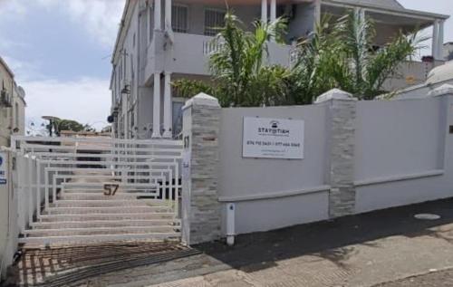 a white fence in front of a house at Stay-Tiah Whyte, Durban in Durban