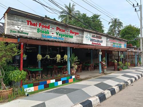 a restaurant on the side of a street at Easy sleep in Ban Mo Nae