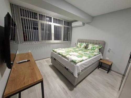 a bedroom with a bed and a table and a table at Numbers in Ruse