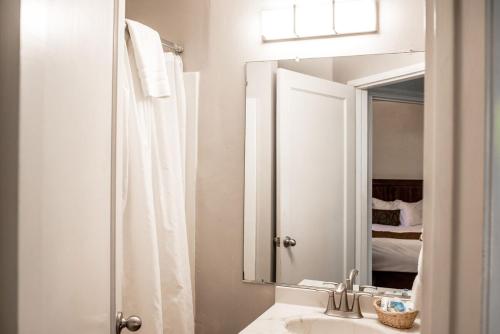 a white bathroom with a sink and a mirror at Charming Yosemite Basecamp - Walk to Downtown in Mariposa