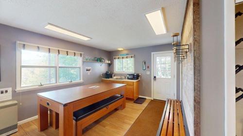 a kitchen with a wooden table and a sink at Silver Spring Chalet in Pittsfield