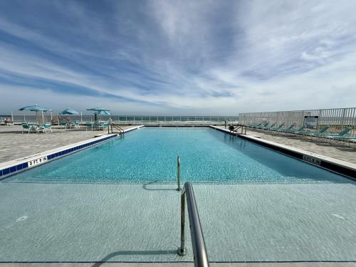 a large swimming pool on top of a building at SeaBliss, oceanfront 1st floor cozy condo in Daytona Beach