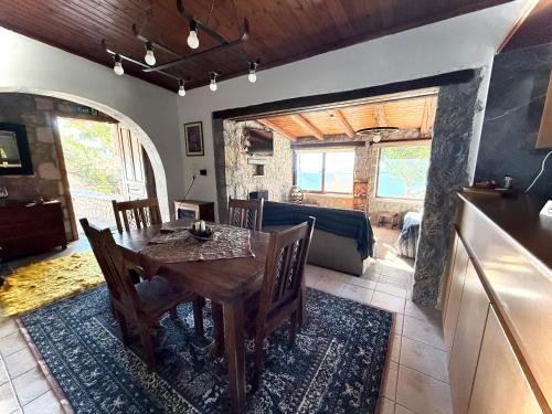 a dining room with a table and a couch at Cozy view Arachova in Arachova