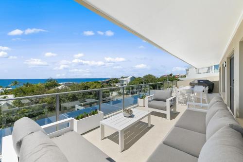 a balcony with furniture and a view of the ocean at Crystal Shores Sunshine Beach in Sunshine Beach