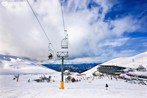 a person on a ski lift in the snow at Cozy view Arachova in Arachova