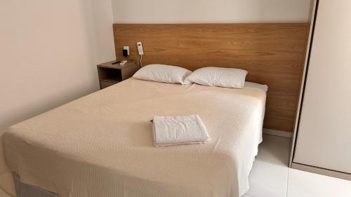 a bed with two white pillows on top of it at Dona Olivia Residencial in Vitória da Conquista