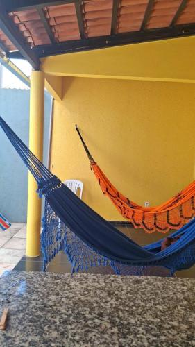 an orange and blue hammock sitting on a porch at Casa das dunas in Prea