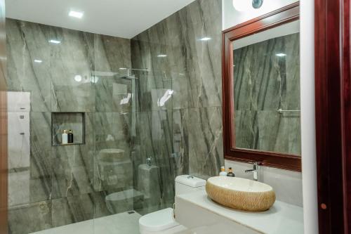 a bathroom with a shower and a toilet and a sink at Hotel Sanctuarium in Fortuna