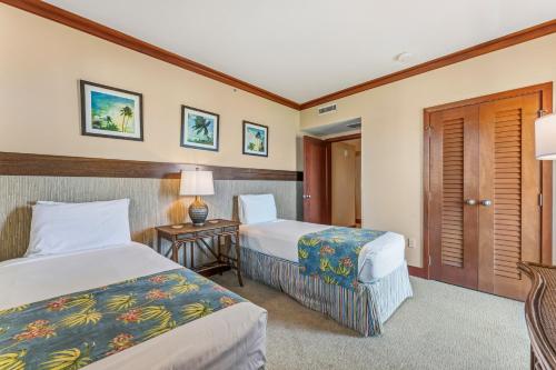 a hotel room with two beds and a table at Beach Villas at Ko Olina 8th floor Ocean View in Kapolei