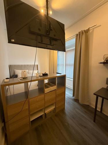 a kitchen with a counter with a sink and a stove at Home From Home in Liverpool