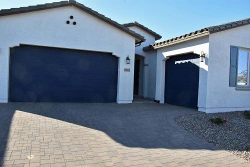 a garage with a blue garage door on a house at BnB Vacation Home in Queen Creek