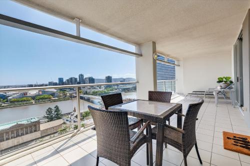 a balcony with a table and chairs and a large window at Hampton's Haven on Level 17 in Casino Towers in Brisbane
