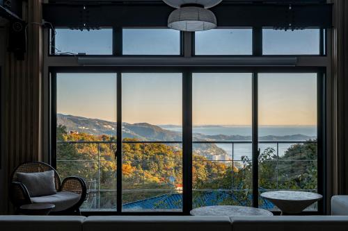 a room with a large window with a view of a pool at Amao Villa 自然郷 in Atami