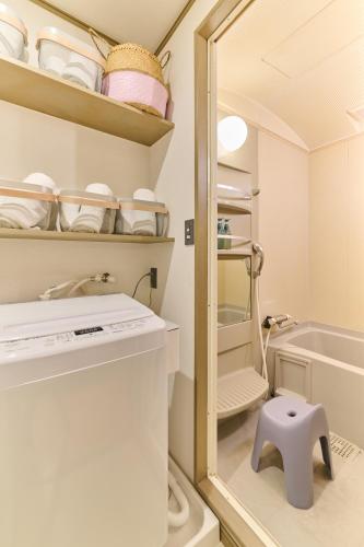 a small kitchen with a sink and a mirror at Valley 3F - Mid Century Modern Kawaramachi Apt in Takamatsu