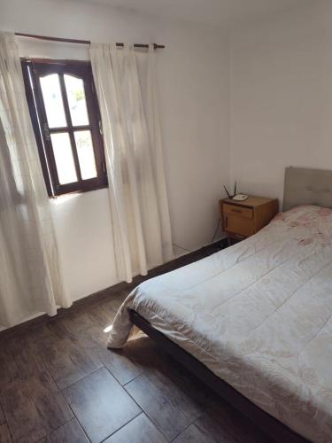 a bedroom with a bed and a window at Benito Soria 137 in Santa Rosa de Calamuchita