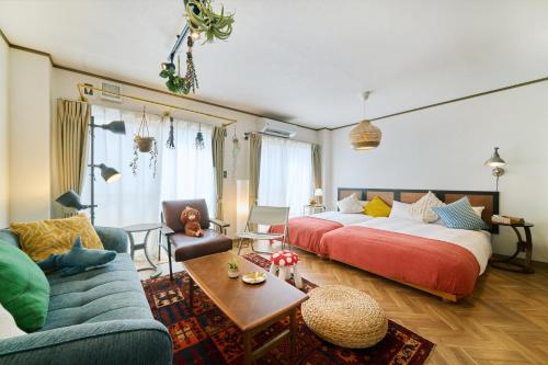 a hotel room with a bed and a couch at Valley 3F - Mid Century Modern Kawaramachi Apt in Takamatsu