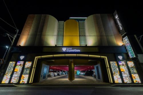 a building with an entrance to a parking garage at night at ホテルクリスタルゲート木更津 in Kisarazu