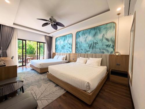 Postel nebo postele na pokoji v ubytování Dawn Boutique Luangprabang Hotel