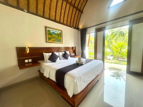 Postel nebo postele na pokoji v ubytování The Lebah Kelingking Villa