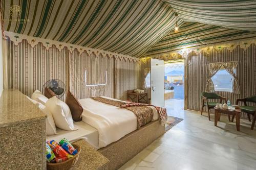 a bedroom with a large bed in a room at Jaisan Heritage Desert Camp in Jaisalmer