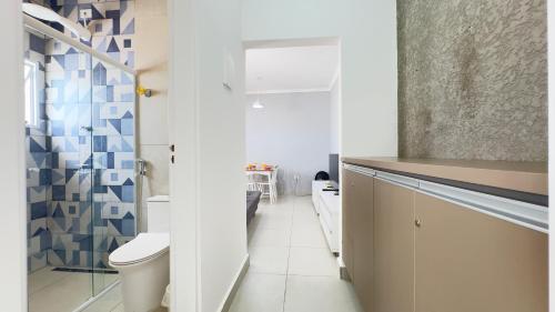 a small bathroom with a toilet and a sink at Cantinho Perfeito para Dois Conforto e Mar Bem Pertinho, Casa terrea no centro 80M Praia, Ar, Enxoval,Estacionamento e churrasqueira in Itanhaém