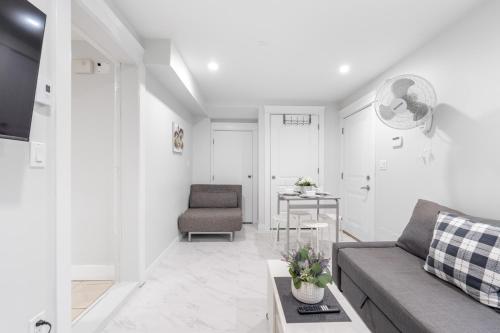 a living room with a couch and a table at Cozy and Modern 2br guesthouse in Vancouver