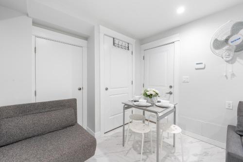 a living room with a table and a couch at Cozy and Modern 2br guesthouse in Vancouver