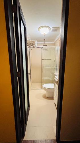 a bathroom with a toilet and a shower at Casa Pichay Family Room in Vigan