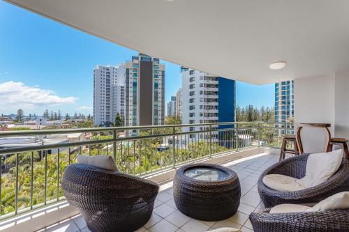 a balcony with chairs and a fire pit on a building at The Meriton Apartments on Main Beach in Gold Coast