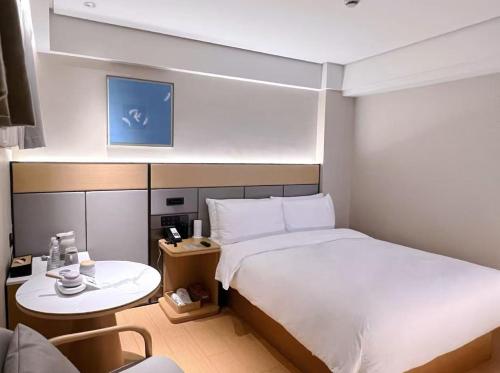 Ένα ή περισσότερα κρεβάτια σε δωμάτιο στο JI Hotel Shanghai Hailun Road Subway Station