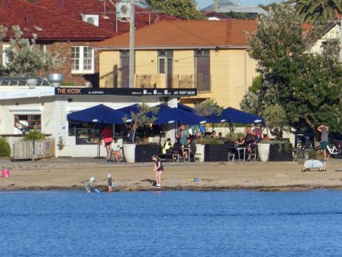 two children playing on the beach next to the water at Modern room in Williamstown in Williamstown