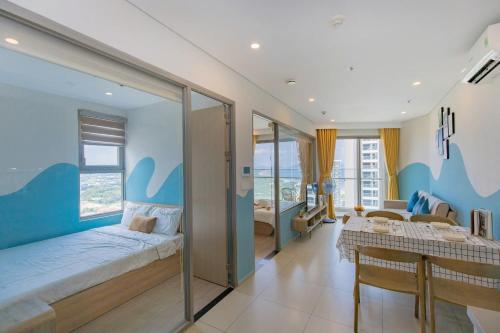 a bedroom with a bed and a living room at THE SONG CĂN HỘ GẦN BÃI SAU THÁP TAM THẮNG - Po'sHomestay Luxury Bãi Sau in Vung Tau